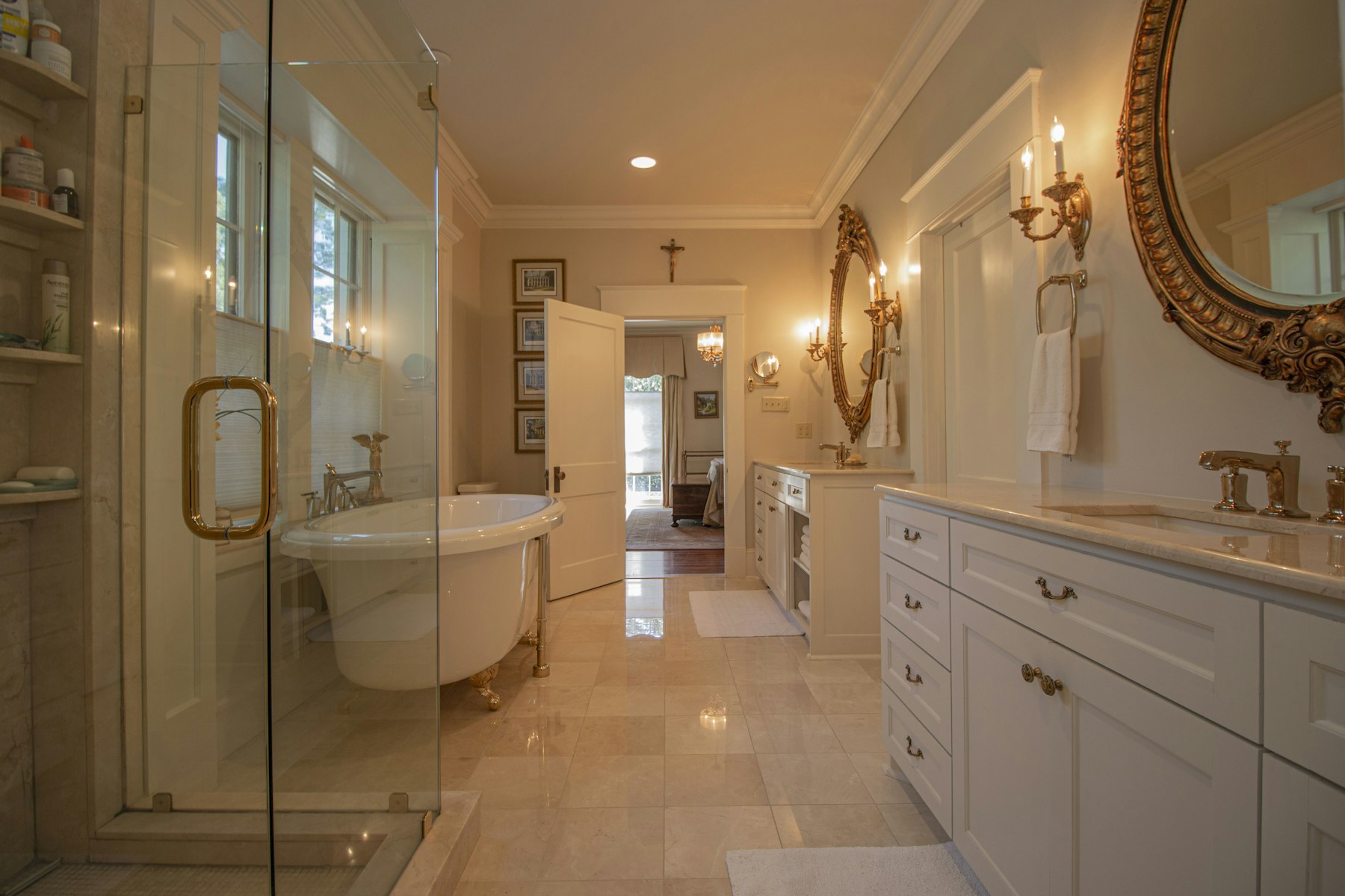 A glass-enclosed shower beside a timber vanity