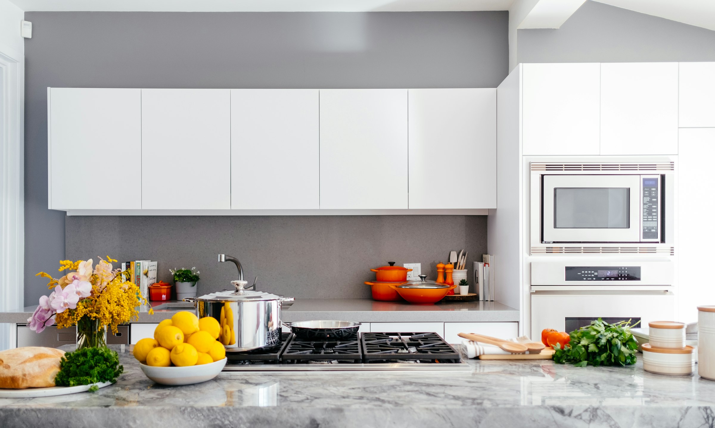 A kitchen with marble countertops and a large island, representative of a full kitchen layout redesign