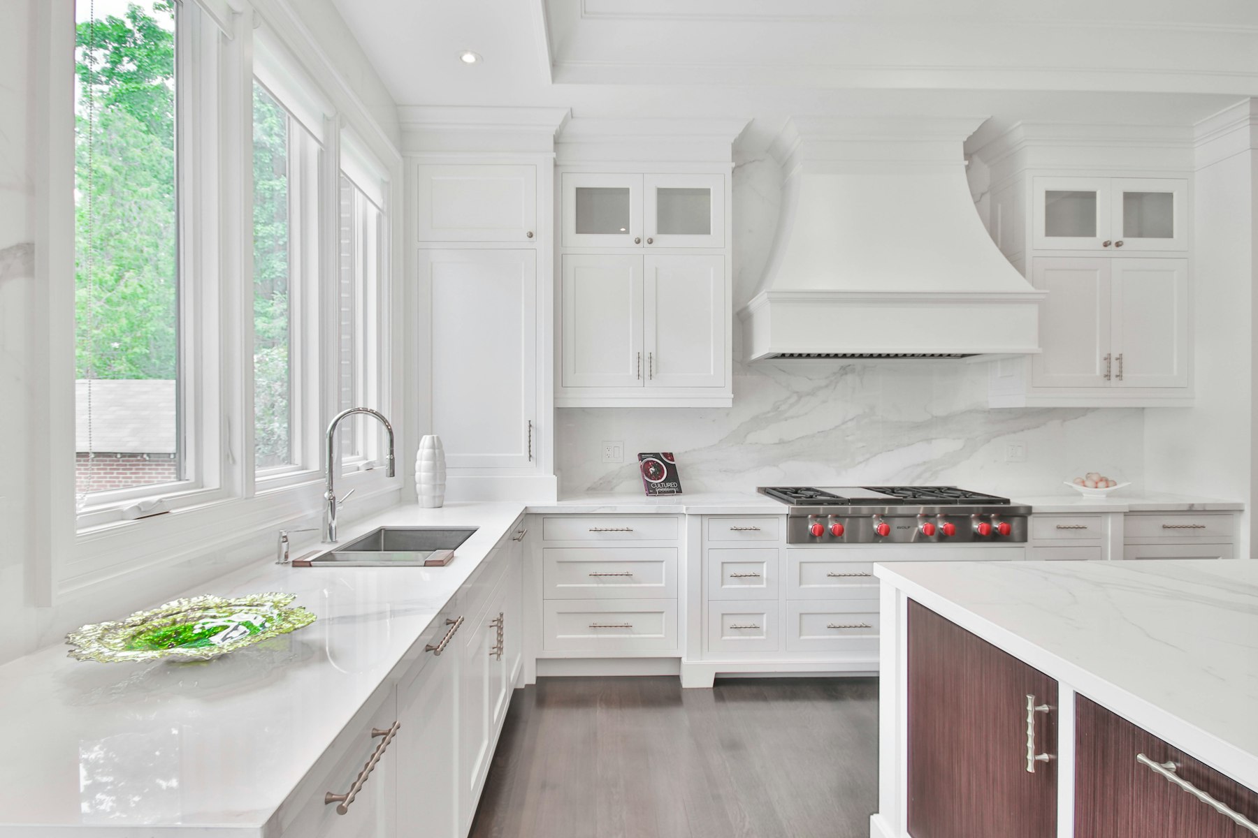 Bright kitchen with a farmhouse sink and clean cabinetry, representative of a full kitchen layout redesign