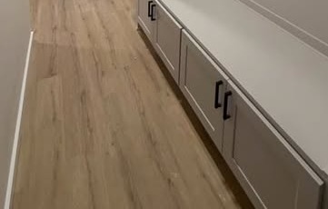 Built-in bench and drawers with matte-black hardware, from a custom closets and mudroom millwork project