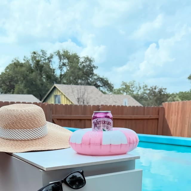 A styled poolside vignette staged on the weather-proof outdoor cabinetry Magnolia Austin built beside this Austin pool